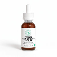Bottle of peptide hair growth serum with a white label on a white background