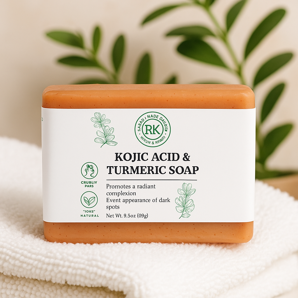 Kojic Acid & Turmeric Soap bar with RK label on a white towel with green leaves in the background